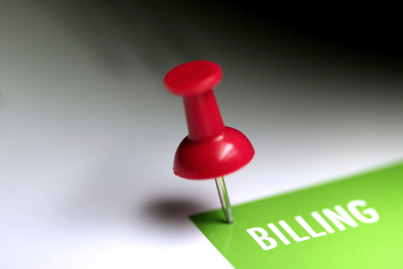 Red push pin with the word billing